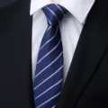 Close-up detail of a classic men's blue striped tie paired with a white dress shirt. - A080 Style Blue Stripe