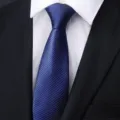 Close-up detail of the blue striped men business necktie, showcasing fine fabric texture. - Sea Breeze Blue