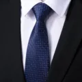 Close-up detail of a blue business formal men's tie with geometric woven pattern. - Blue Ladder Texture
