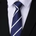 Close-up of classic navy blue necktie featuring clean white diagonal stripes and textured fabric. - Blue Stripe