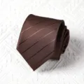 Close-up view of a brown striped tie, rolled neatly showing fine fabric texture and pattern. - Handmade Style / 8cm / Coffee Stripes