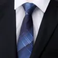 Close-up view of the blue plaid men's business necktie fabric texture and knot detail. - New Model 027 Blue Grid