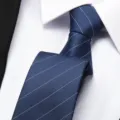 Detailed close-up view of a classic blue striped business necktie paired with a white dress shirt. - 8cm Elegant Blue Stripe Zipper