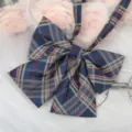 Detailed close-up of a Japanese JK style navy blue plaid bow tie with ribbons, apparel accessory. - Dark Blue Yellow Plaid Ribbon Bow