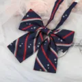 Detailed close-up of a Japanese JK uniform bow tie featuring navy blue, red stripes, and star embroidery. - Navy Blue Star Bowtie