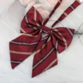 Detailed shot of dark red striped JK bow tie ribbon, featuring classic diagonal stripes. - Akakonda Gold Striped Collar Flower