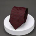 Detailed close-up view of a classic black and red patterned mens business suit necktie. - H023