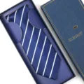Closeup view of a navy blue striped necktie neatly placed in a luxury gift box for men. - Zipper Style / Long Box / Navy Blue Fine Stripes