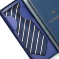 Close-up of the elegant navy blue striped tie neatly displayed in the luxury gift box. - Zipper Style / Long Box / Dark Blue & Yellow Stripe