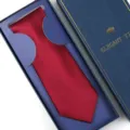 Red silk necktie in elegant blue gift box, classic solid color formal menswear variant. - Zipper Style / Long Box / Burgundy Glossy