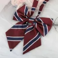 Detailed close-up view of the maroon JK uniform ribbon bow featuring classic stripe design. - Burgundy Dark Blue Striped Bow Tie