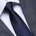 Close-up detail of men's blue striped business necktie matched with white shirt and suit. - Navy Double Line Zipper Style / 8cm