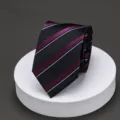 Close-up detail view of the elegant black and purple striped necktie displayed neatly. - Y20 Black Purple Stripe