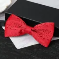 Red patterned bow tie detail showing exquisite textured fabric, perfect for formal wedding suits. - Vintage Pattern Bowtie