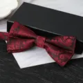 Detailed close-up of a burgundy paisley bow tie for men, elegant wedding formal wear accessory. - Court Pattern Bowtie