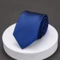 Detailed view of the classic blue striped men's tie, showing fine texture and neat roll. - B1 Bright Blue Stripe