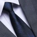 Close-up detail of a mens classic blue geometric patterned business tie with suit jacket and shirt. - Blue Intertwined Texture Zipper Style / 8cm