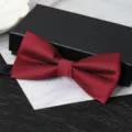 Detail view of a wine red double-layer bow tie with fine herringbone pattern for formal wear. - Wine Red Wave Bowtie