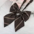 Dark brown plaid JK uniform bow tie detail shot, exquisite striped border ribbon accessory. - Dark Champagne Gold Stripe Ribbon Bow