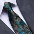 Close-up of elegant men's paisley business tie in teal and gold with suit jacket detail. - Blue and White Porcelain Zipper Style / 8cm