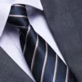 Men's business navy blue striped necktie close-up detail showcasing fine woven texture. - Dark Blue and Yellow Stripe Zipper Style / 8cm