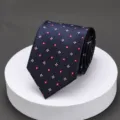 Detailed view of a classic dark blue men's business necktie with red and white cross pattern. - LK Navy Red White Floral