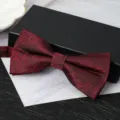Close-up detail of the elegant burgundy textured bow tie showcasing refined craftsmanship. - Knight Wine Red Bowtie
