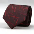 Detailed shot of a stylish men's business red geometric patterned necktie for formal wear. - Burgundy Snowflake