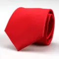 Close-up view of the rolled bright red necktie for men formal business wear. - Vibrant Red Solid Style