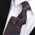 Classic dark blue paisley necktie featuring elegant orange patterns, ideal for formal business wear. - 8cm Royal Imperial Hand-Tied