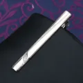 Close-up of a stylish silver metal tie clip featuring elegant engraved patterns and stone. - Tie Clip J10 (Gift Box)