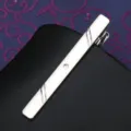 Close up of a sleek silver tie clip featuring elegant striped engravings and a sparkling crystal. - Tie Clip J39 (Gift Box)