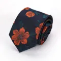 Detailed view of dark blue men tie featuring vibrant orange floral woven pattern elegant. - Orange Scenery