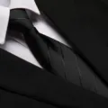 Close-up detail of a classic black business men's tie paired with a crisp white shirt. - 8cm Black Dark Stripe Zipper
