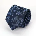 Close-up detail of dark blue necktie featuring delicate light blue floral pattern texture. - Navy Blue