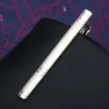 Detailed close-up shot of a sleek silver metal tie clip featuring a stylish striped texture. - Tie Clip J55 (Gift Box)