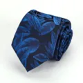 Detailed view of a dark blue necktie featuring an elegant blue leaf pattern texture. - Fantasy Nebula