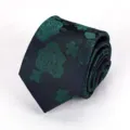 Detailed shot of a rolled dark necktie featuring green floral jacquard rose pattern. - Evergreen