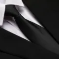 Close-up view of a classic black business necktie paired with a crisp white shirt and suit. - 8cm Black Meteor Zipper