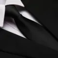 Detailed close-up view of classic black silk tie with white shirt collar for business men. - 8cm Black Fine Stripe Zipper