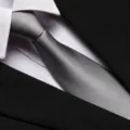 Detail view of a professional men's grey business tie with clear twill texture. - 8cm Light Gray Fine Stripe Zipper