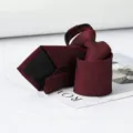 Detailed close-up shot of a burgundy zipper pre-tied necktie featuring fine textured fabric. - Calm Burgundy Zipper Tie