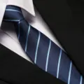 Detailed close-up of a stylish blue striped business necktie paired with a crisp white shirt and black suit. - 8cm A080 Zipper