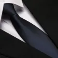 Close-up detail of a dark blue striped business necktie paired with a white shirt. - 8cm Navy Meteor Zipper