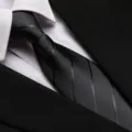 Detailed close-up of a classic black business necktie paired with a crisp white shirt and suit. - 8cm Dark Gray Dark Stripe Zipper