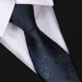 Close-up detail of dark blue floral necktie for business wear. Stylish retro design for men. - Blue Mist Floral