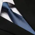 Detailed view of a stylish blue textured business necktie paired with white shirt and suit. - 8cm Ocean Blue Fine Stripe Zipper