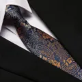 Detail view of a classic blue paisley necktie paired with a crisp white shirt. - 8cm Royal Style Paisley Zipper