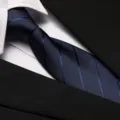 Detailed view of professional blue striped business necktie matching formal suit jacket. - 8cm Blue Dark Stripe Zipper