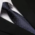 Detailed view of a professional blue patterned business tie paired with a crisp shirt collar and suit. - 8cm Fine Floral Houndstooth Zipper